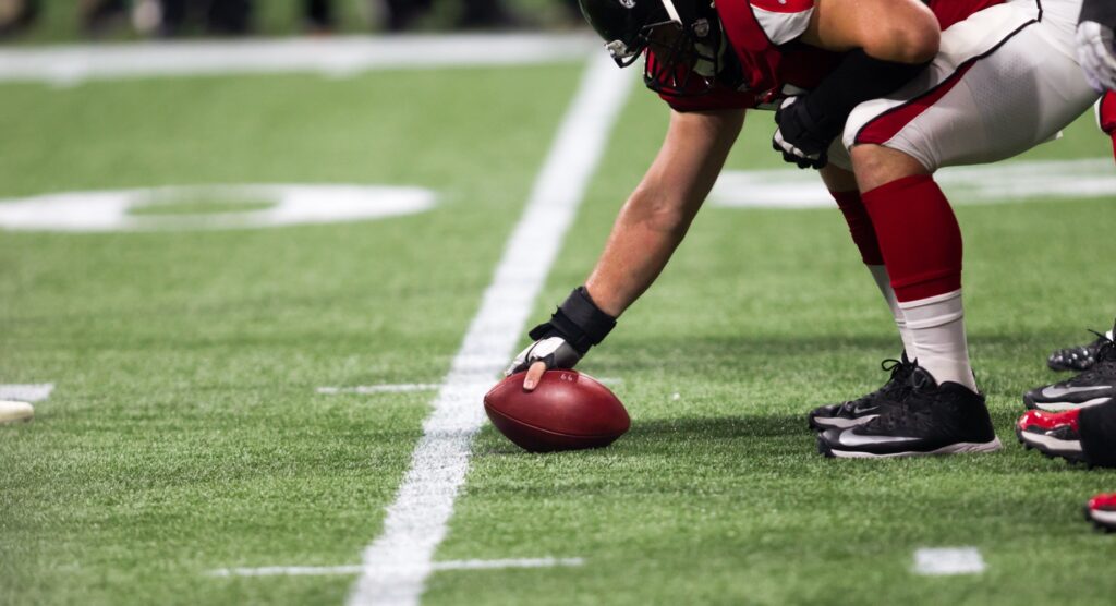 NFL player snapping the ball